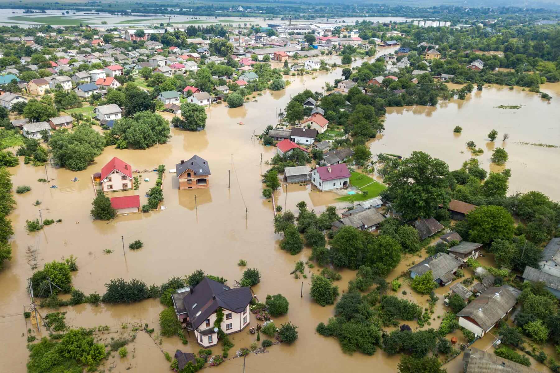 Aerial view of flooded houses with dirty water